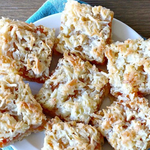 Apricot Shortbread Bars | these luscious #cookies have a #shortbread crust, spread with #Apricot jelly & topped with a scrumptious #coconut topping. Terrific for #tailgating parties, potlucks or #ChristmasCookieExchanges. #dessert #ApricotDessert #HolidayDessert #ApricotShortbreadBars