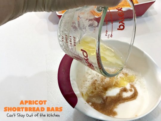 Apricot Shortbread Bars | these luscious #cookies have a #shortbread crust, spread with #Apricot jelly & topped with a scrumptious #coconut topping. Terrific for #tailgating parties, potlucks or #ChristmasCookieExchanges. #dessert #ApricotDessert #HolidayDessert #ApricotShortbreadBars