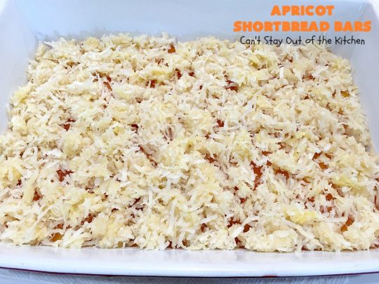 Apricot Shortbread Bars | these luscious #cookies have a #shortbread crust, spread with #Apricot jelly & topped with a scrumptious #coconut topping. Terrific for #tailgating parties, potlucks or #ChristmasCookieExchanges. #dessert #ApricotDessert #HolidayDessert #ApricotShortbreadBars