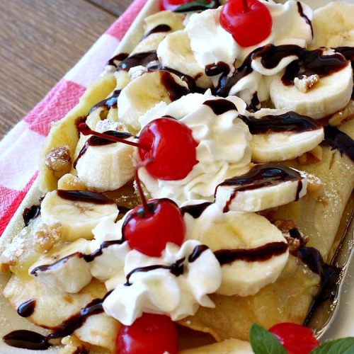 Banana Split Breakfast Crêpes | Can't Stay Out of the Kitchen | these spectacular #breakfast #crêpes will rock your world! They're filling with a #pineapple filling & sliced #bananas. Then garnished with #walnuts, bananas #MaraschinoCherries & whipped cream. Perfect for a company or #holiday breakfast. #BreakfastCrêpes #BananaSplit #BananaSplitBreakfastCrêpes