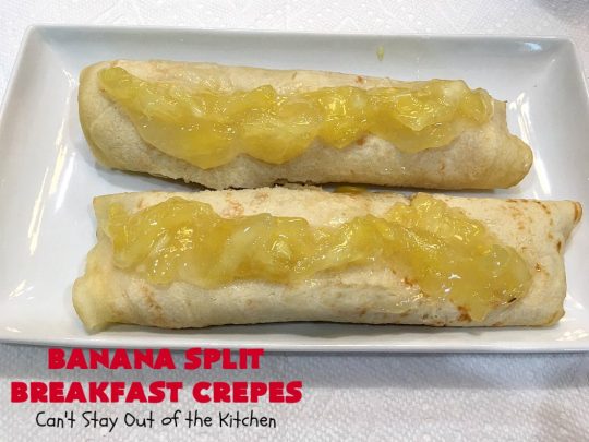 Banana Split Breakfast Crêpes | Can't Stay Out of the Kitchen | these spectacular #breakfast #crêpes will rock your world! They're filling with a #pineapple filling & sliced #bananas. Then garnished with #walnuts, bananas #MaraschinoCherries & whipped cream. Perfect for a company or #holiday breakfast. #BreakfastCrêpes #BananaSplit #BananaSplitBreakfastCrêpes
