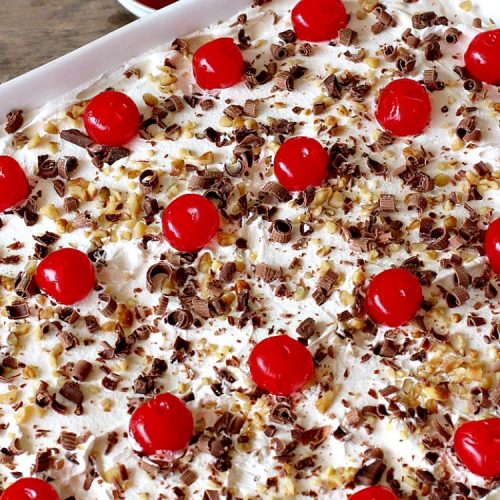 Black Forest Dream Dessert | Can't Stay Out of the Kitchen | this spectacular #dessert has a crust layer with #pecans & #coconut. It also has #cheesecake layer, a #cherrypiefilling layer, a vanilla pudding layer with melted #chocolatechips added, & a top layer with #CoolWhip, #maraschinocherries, #chocolate curls & chopped #pecans. Absolutely divine! #BlackForestDessert #CherryDessert #ChocolateDessert #ValentinesDay #ValentinesDayDessert #ChristmasDessert #CheesecakeDessert