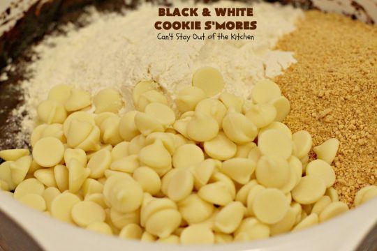Black and White Cookie S'Mores | Can't Stay Out of the Kitchen | this fantastic #PaulaDeen #recipe includes #chocolate bars, #GrahamCrackers and #WhiteChocolateChips in the #cookie. Each one is put together with #MarshmallowCreme. These are the ultimate in #SmoresCookie! Great for #holiday #baking & #ChristmasCookieExchanges too. #Smores #dessert #SmoresDessert #BlackAndWhiteCookieSMores