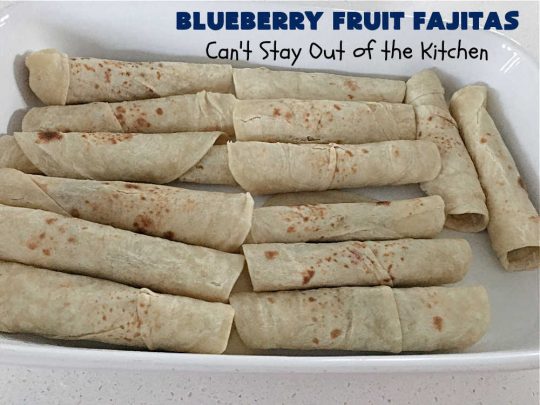 Blueberry Fruit Fajitas | Can't Stay Out of the Kitchen | These lovely #FruitFajitas use #BlueberryPieFilling and are wrapped in #tortillas. Then they're saturated in a lovely syrup before baking. This delightful #recipe is great for #dessert but since they're like #crepes we enjoy them for #breakfast too. #HolidayDessert #BlueberryDessert #CincoDeMayo #Blueberries #BlueberryFruitFajitas