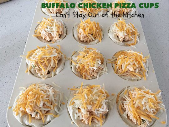 Buffalo Chicken Pizza Cups | Can't Stay Out of the Kitchen | these scrumptious miniature #pizzas include #BuffaloChickenDip in the centers & they're topped with 3 #cheeses including #mozzarella, #TacoCheese & #BlueCheese crumbles. Sensational #appetizer for #holidays, #tailgating parties, potlucks or the #SuperBowl. #BuffaloChicken #chicken #BuffaloChickenPizzaCups