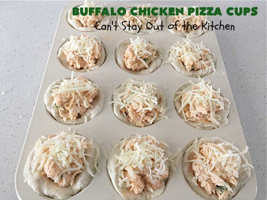 Buffalo Chicken Pizza Cups | Can't Stay Out of the Kitchen | these scrumptious miniature #pizzas include #BuffaloChickenDip in the centers & they're topped with 3 #cheeses including #mozzarella, #TacoCheese & #BlueCheese crumbles. Sensational #appetizer for #holidays, #tailgating parties, potlucks or the #SuperBowl. #BuffaloChicken #chicken #BuffaloChickenPizzaCups