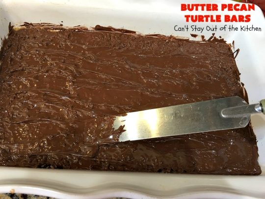 Butter Pecan Turtle Bars | These amazing layered #cookies have a shortbread crust. They're topped with #pecans & a homemade #caramel layer. Then they're covered with #chocolatechips while hot. That layer is spread into a delicious #chocolate icing. Perfect for #tailgating parties, soccer games, backyard barbecues, baby showers or potlucks. #ChocolateDessert #ButterPecanDessert #TurtleDessert #TurtleBars