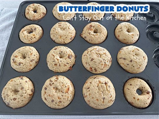 Butterfinger Donuts | Can't Stay Out of the Kitchen | Prepare to swoon over every delicious bite of #ButterfingerDonuts! These luscious #donuts include #Butterfingers in the donut as well as on top of the #ChocolateFrosting. Every bite will rock your world! Terrific for a weekend, company or #holiday breakfast or #brunch. #HolidayBreakfast #BakedDonuts #ButterfingerCandyBars