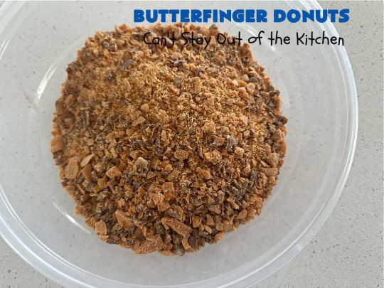 Butterfinger Donuts | Can't Stay Out of the Kitchen | Prepare to swoon over every delicious bite of #ButterfingerDonuts! These luscious #donuts include #Butterfingers in the donut as well as on top of the #ChocolateFrosting. Every bite will rock your world! Terrific for a weekend, company or #holiday breakfast or #brunch. #HolidayBreakfast #BakedDonuts #ButterfingerCandyBars