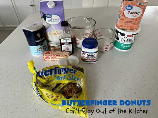 Butterfinger Donuts | Can't Stay Out of the Kitchen | Prepare to swoon over every delicious bite of #ButterfingerDonuts! These luscious #donuts include #Butterfingers in the donut as well as on top of the #ChocolateFrosting. Every bite will rock your world! Terrific for a weekend, company or #holiday breakfast or #brunch. #HolidayBreakfast #BakedDonuts #ButterfingerCandyBars