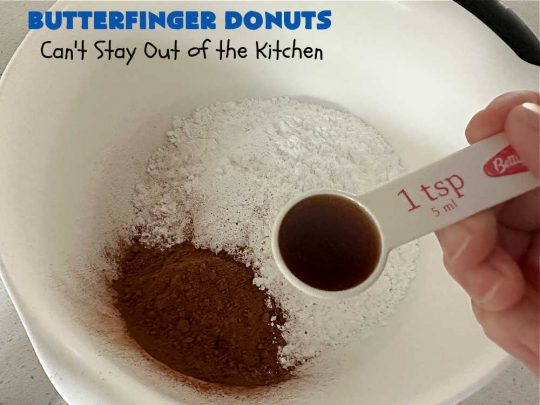 Butterfinger Donuts | Can't Stay Out of the Kitchen | Prepare to swoon over every delicious bite of #ButterfingerDonuts! These luscious #donuts include #Butterfingers in the donut as well as on top of the #ChocolateFrosting. Every bite will rock your world! Terrific for a weekend, company or #holiday breakfast or #brunch. #HolidayBreakfast #BakedDonuts #ButterfingerCandyBars