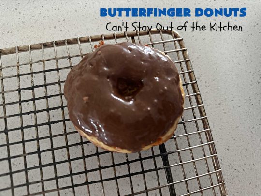 Butterfinger Donuts | Can't Stay Out of the Kitchen | Prepare to swoon over every delicious bite of #ButterfingerDonuts! These luscious #donuts include #Butterfingers in the donut as well as on top of the #ChocolateFrosting. Every bite will rock your world! Terrific for a weekend, company or #holiday breakfast or #brunch. #HolidayBreakfast #BakedDonuts #ButterfingerCandyBars