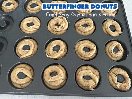 Butterfinger Donuts | Can't Stay Out of the Kitchen | Prepare to swoon over every delicious bite of #ButterfingerDonuts! These luscious #donuts include #Butterfingers in the donut as well as on top of the #ChocolateFrosting. Every bite will rock your world! Terrific for a weekend, company or #holiday breakfast or #brunch. #HolidayBreakfast #BakedDonuts #ButterfingerCandyBars