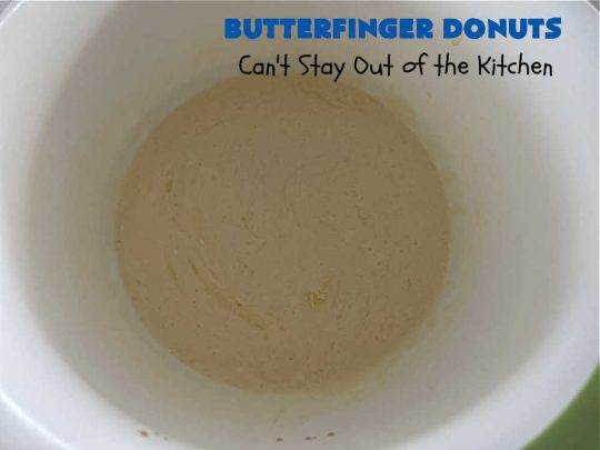 Butterfinger Donuts | Can't Stay Out of the Kitchen | Prepare to swoon over every delicious bite of #ButterfingerDonuts! These luscious #donuts include #Butterfingers in the donut as well as on top of the #ChocolateFrosting. Every bite will rock your world! Terrific for a weekend, company or #holiday breakfast or #brunch. #HolidayBreakfast #BakedDonuts #ButterfingerCandyBars
