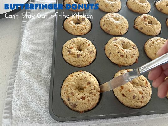 Butterfinger Donuts | Can't Stay Out of the Kitchen | Prepare to swoon over every delicious bite of #ButterfingerDonuts! These luscious #donuts include #Butterfingers in the donut as well as on top of the #ChocolateFrosting. Every bite will rock your world! Terrific for a weekend, company or #holiday breakfast or #brunch. #HolidayBreakfast #BakedDonuts #ButterfingerCandyBars