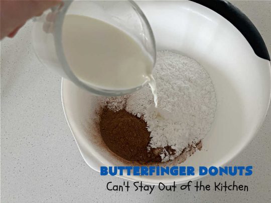 Butterfinger Donuts | Can't Stay Out of the Kitchen | Prepare to swoon over every delicious bite of #ButterfingerDonuts! These luscious #donuts include #Butterfingers in the donut as well as on top of the #ChocolateFrosting. Every bite will rock your world! Terrific for a weekend, company or #holiday breakfast or #brunch. #HolidayBreakfast #BakedDonuts #ButterfingerCandyBars