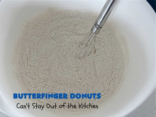 Butterfinger Donuts | Can't Stay Out of the Kitchen | Prepare to swoon over every delicious bite of #ButterfingerDonuts! These luscious #donuts include #Butterfingers in the donut as well as on top of the #ChocolateFrosting. Every bite will rock your world! Terrific for a weekend, company or #holiday breakfast or #brunch. #HolidayBreakfast #BakedDonuts #ButterfingerCandyBars