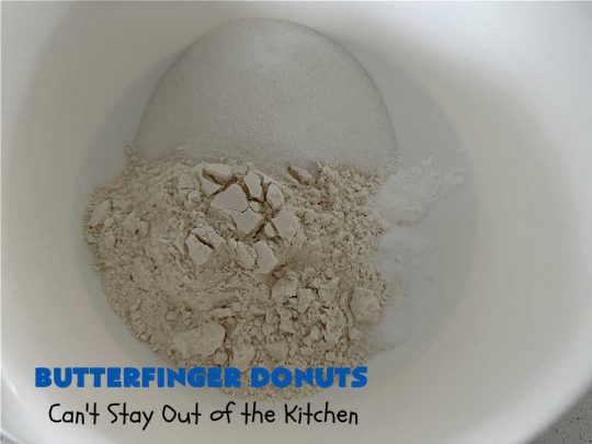 Butterfinger Donuts | Can't Stay Out of the Kitchen | Prepare to swoon over every delicious bite of #ButterfingerDonuts! These luscious #donuts include #Butterfingers in the donut as well as on top of the #ChocolateFrosting. Every bite will rock your world! Terrific for a weekend, company or #holiday breakfast or #brunch. #HolidayBreakfast #BakedDonuts #ButterfingerCandyBars