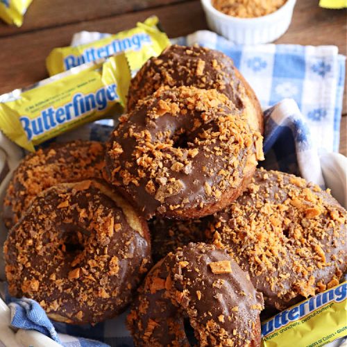 Butterfinger Donuts | Can't Stay Out of the Kitchen | Prepare to swoon over every delicious bite of #ButterfingerDonuts! These luscious #donuts include #Butterfingers in the donut as well as on top of the #ChocolateFrosting. Every bite will rock your world! Terrific for a weekend, company or #holiday breakfast or #brunch. #HolidayBreakfast #BakedDonuts #ButterfingerCandyBars