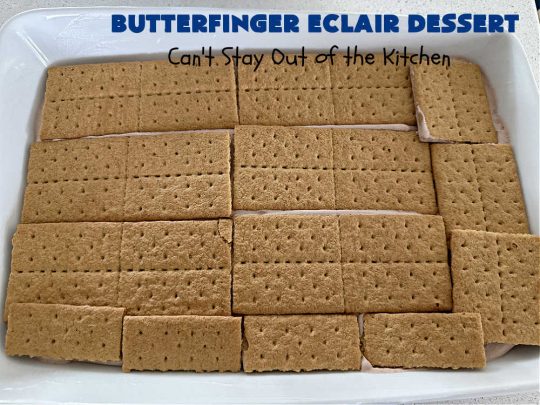 Butterfinger Éclair Dessert | Can't Stay Out of the Kitchen | this spectacular #ButterfingerÉclairDessert uses only 6 ingredients & is the perfect #dessert for company or #holidays. It serves a crowd & everyone enjoys the #GrahamCracker, #ChocolatePudding & #ChocolateFrosting layers that mimic Éclairs. You & your friends will swoon over this delicious #ButterfingerDessert. #Chocolate #ChocolateDessert #ButterfingerCandyBars