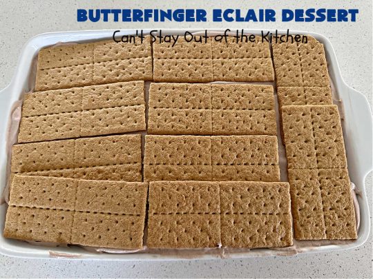 Butterfinger Éclair Dessert | Can't Stay Out of the Kitchen | this spectacular #ButterfingerÉclairDessert uses only 6 ingredients & is the perfect #dessert for company or #holidays. It serves a crowd & everyone enjoys the #GrahamCracker, #ChocolatePudding & #ChocolateFrosting layers that mimic Éclairs. You & your friends will swoon over this delicious #ButterfingerDessert. #Chocolate #ChocolateDessert #ButterfingerCandyBars