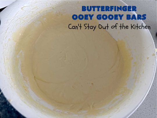 Butterfinger Ooey Gooey Bars | Can't Stay Out of the Kitchen | these lovely #OoeyGooeyBars include a #Cheesecake filling with chopped #Butterfingers on top! This easy 6-ingredient #recipe is so irresistible everyone will want seconds. They are out of this world good & will have you swooning from the first bite. Excellent for #tailgating, potlucks & a #ChristmasCookieExchange. #cookie #brownie #dessert #ButterfingerDessert #ButterfingerOoeyGooeyBars