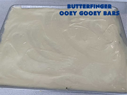 Butterfinger Ooey Gooey Bars | Can't Stay Out of the Kitchen | these lovely #OoeyGooeyBars include a #Cheesecake filling with chopped #Butterfingers on top! This easy 6-ingredient #recipe is so irresistible everyone will want seconds. They are out of this world good & will have you swooning from the first bite. Excellent for #tailgating, potlucks & a #ChristmasCookieExchange. #cookie #brownie #dessert #ButterfingerDessert #ButterfingerOoeyGooeyBars