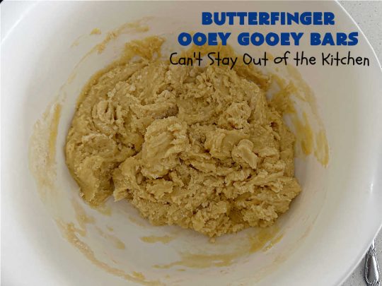 Butterfinger Ooey Gooey Bars | Can't Stay Out of the Kitchen | these lovely #OoeyGooeyBars include a #Cheesecake filling with chopped #Butterfingers on top! This easy 6-ingredient #recipe is so irresistible everyone will want seconds. They are out of this world good & will have you swooning from the first bite. Excellent for #tailgating, potlucks & a #ChristmasCookieExchange. #cookie #brownie #dessert #ButterfingerDessert #ButterfingerOoeyGooeyBars