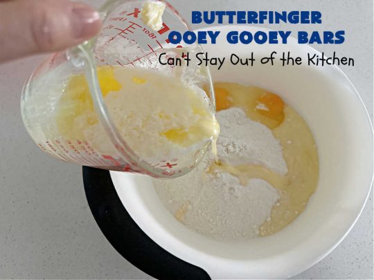 Butterfinger Ooey Gooey Bars | Can't Stay Out of the Kitchen | these lovely #OoeyGooeyBars include a #Cheesecake filling with chopped #Butterfingers on top! This easy 6-ingredient #recipe is so irresistible everyone will want seconds. They are out of this world good & will have you swooning from the first bite. Excellent for #tailgating, potlucks & a #ChristmasCookieExchange. #cookie #brownie #dessert #ButterfingerDessert #ButterfingerOoeyGooeyBars