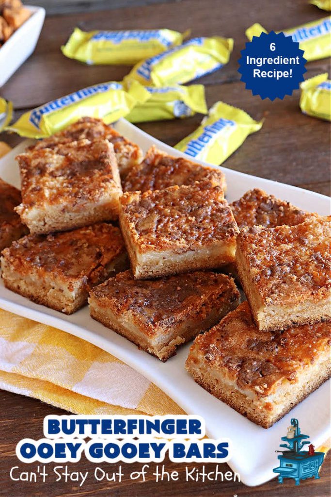 Butterfinger Ooey Gooey Bars | Can't Stay Out of the Kitchen | these lovely #OoeyGooeyBars include a #Cheesecake filling with chopped #Butterfingers on top! This easy 6-ingredient #recipe is so irresistible everyone will want seconds. They are out of this world good & will have you swooning from the first bite. Excellent for #tailgating, potlucks & a #ChristmasCookieExchange. #cookie #brownie #dessert #ButterfingerDessert #ButterfingerOoeyGooeyBars