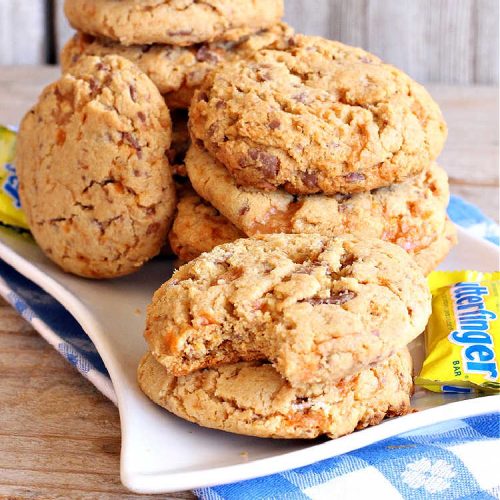 Butterfinger Surprises | Can't Stay Out of the Kitchen | these luscious #PeanutButterCookies include #ButterfingerBits in every bite. These whopper-sized #cookies will knock your socks off! If you enjoy #PeanutButter #chocolate & #Butterfingers, this #dessert will make your day! #ChocolateDessert #PeanutButterDessert #Butterfinger Dessert #holiday #HolidayBaking #HolidayDessert #ButterfingerSurprises