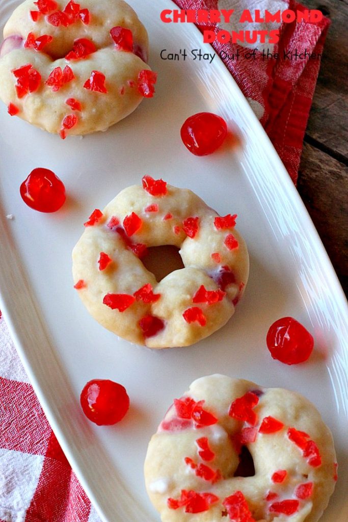 Cherry Almond Donuts | Can't Stay Out of the Kitchen | these luscious #donuts are filled with #cherries & #almond extract. They're glazed with an almond-flavored powdered sugar icing & topped with chopped cherries. Perfect for #ValentinesDay or any #holiday #breakfast. #HolidayBreakfast #ValentinesDayBreakfast #CherryDonuts #CherryAlmondDonuts 