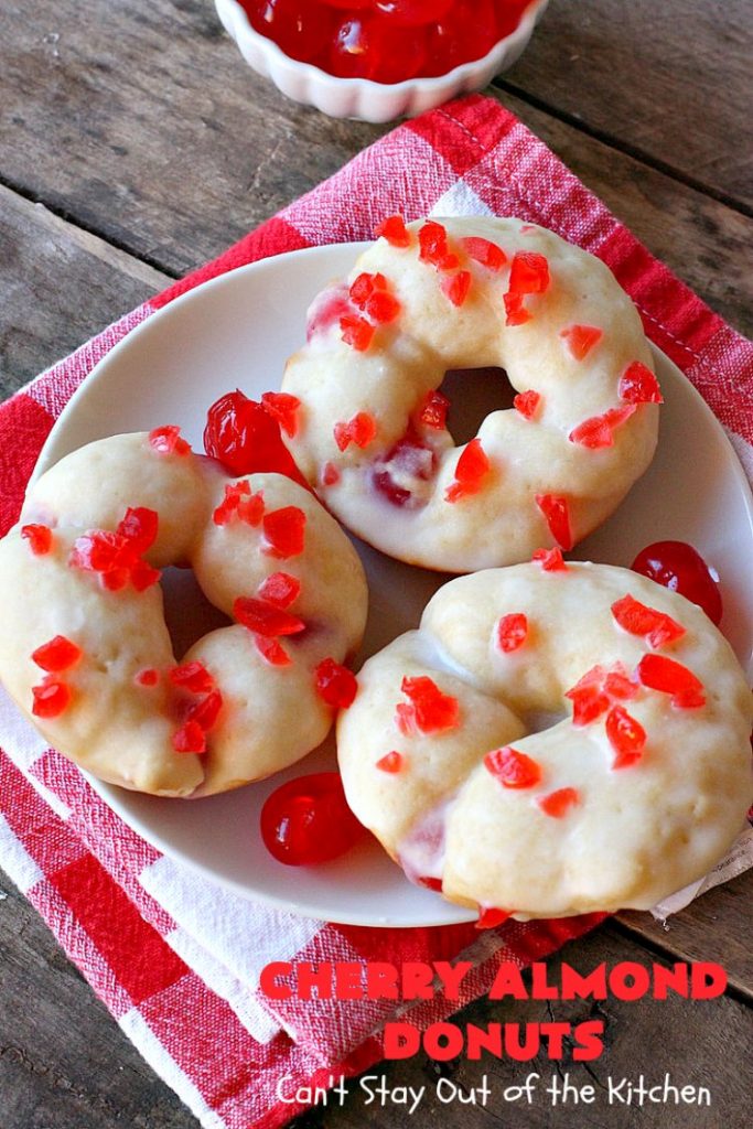 Cherry Almond Donuts | Can't Stay Out of the Kitchen | these luscious #donuts are filled with #cherries & #almond extract. They're glazed with an almond-flavored powdered sugar icing & topped with chopped cherries. Perfect for #ValentinesDay or any #holiday #breakfast. #HolidayBreakfast #ValentinesDayBreakfast #CherryDonuts #CherryAlmondDonuts 