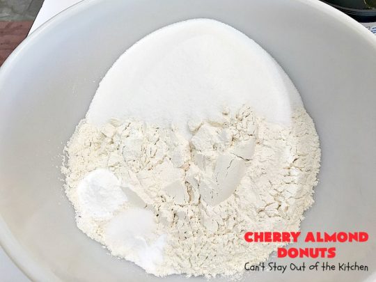 Cherry Almond Donuts | Can't Stay Out of the Kitchen | these luscious #donuts are filled with #cherries & #almond extract. They're glazed with an almond-flavored powdered sugar icing & topped with chopped cherries. Perfect for #ValentinesDay or any #holiday #breakfast. #HolidayBreakfast #ValentinesDayBreakfast #CherryDonuts #CherryAlmondDonuts 