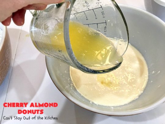 Cherry Almond Donuts | Can't Stay Out of the Kitchen | these luscious #donuts are filled with #cherries & #almond extract. They're glazed with an almond-flavored powdered sugar icing & topped with chopped cherries. Perfect for #ValentinesDay or any #holiday #breakfast. #HolidayBreakfast #ValentinesDayBreakfast #CherryDonuts #CherryAlmondDonuts 