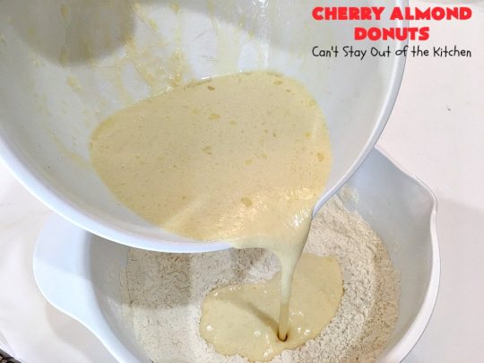 Cherry Almond Donuts | Can't Stay Out of the Kitchen | these luscious #donuts are filled with #cherries & #almond extract. They're glazed with an almond-flavored powdered sugar icing & topped with chopped cherries. Perfect for #ValentinesDay or any #holiday #breakfast. #HolidayBreakfast #ValentinesDayBreakfast #CherryDonuts #CherryAlmondDonuts 