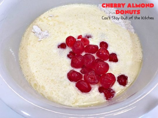 Cherry Almond Donuts | Can't Stay Out of the Kitchen | these luscious #donuts are filled with #cherries & #almond extract. They're glazed with an almond-flavored powdered sugar icing & topped with chopped cherries. Perfect for #ValentinesDay or any #holiday #breakfast. #HolidayBreakfast #ValentinesDayBreakfast #CherryDonuts #CherryAlmondDonuts 