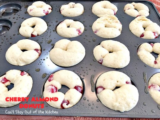Cherry Almond Donuts | Can't Stay Out of the Kitchen | these luscious #donuts are filled with #cherries & #almond extract. They're glazed with an almond-flavored powdered sugar icing & topped with chopped cherries. Perfect for #ValentinesDay or any #holiday #breakfast. #HolidayBreakfast #ValentinesDayBreakfast #CherryDonuts #CherryAlmondDonuts 