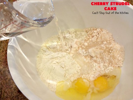 Cherry Strudel Cake | Can't Stay Out of the Kitchen | this rich, decadent #cake is absolutely divine! It's perfect for either a #holiday #breakfast or for #dessert. It uses #CherryPieFilling in the middle, a streusel topping & icing with #almond extract. Tastes like eating #CherryStrudel but so much easier! #coffeecake #CherryCoffeecake #CherryCake #Brunch #HolidayBreakfast #CherryDessert #CherryStrudelCake
