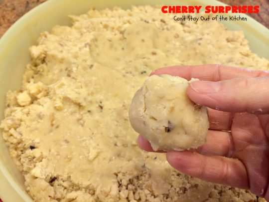 Cherry Surprises | Can't Stay Out of the Kitchen | these melt-in-your-mouth #cookies are absolutely spectacular. #CandiedCherries are hidden inside each #cookie before #baking. Then they're rolled in powdered sugar to serve. These heavenly cookies have been on our #ChristmasCookie baking list for decades! #dessert #Christmas #ChristmasDessert #cherry #CherryDessert #ChristmasCookieExchange