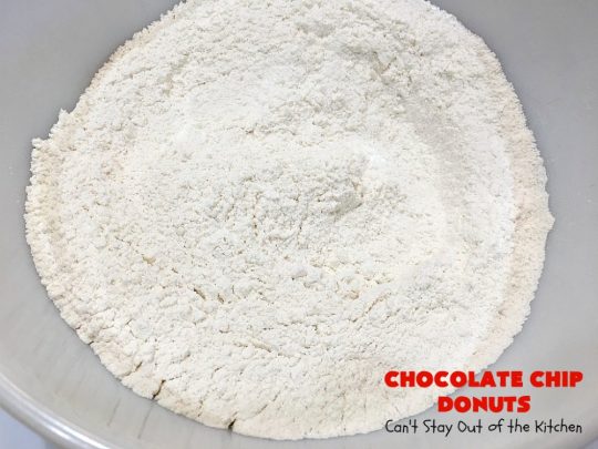 Chocolate Chip Donuts | Can't Stay Out of the Kitchen | these spectacular #donuts are filled with miniature #ChocolateChips. They're glazed with a #chocolate icing and sprinkled with chocolate #sprinkles on top. Mouthwatering #breakfast for #holidays like #MothersDay or #FathersDay. #HolidayBreakfast #FathersDayBreakfast #MothersDayBreakfast #ChocolateChipDonuts