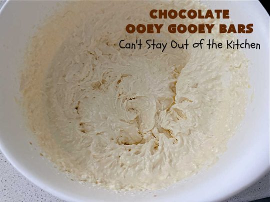 Chocolate Ooey Gooey Bars | Can't Stay Out of the Kitchen | You'll be raving over every drool-worthy bite of these fantastic #OoeyGooeyBars. They're made with 3 kinds of #chocolate & just ooze deliciousness in every bite. The #Cheesecake layer alone will leave you swooning! #cookie #brownie #tailgating #dessert, #CreamCheese #ChocolateChips #ChocolateDessert #HolidayDessert #OoeyGooeyDessert #ChocolateOoeyGooeyBars