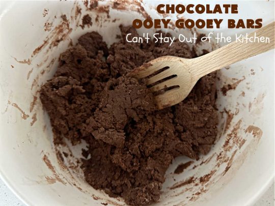 Chocolate Ooey Gooey Bars | Can't Stay Out of the Kitchen | You'll be raving over every drool-worthy bite of these fantastic #OoeyGooeyBars. They're made with 3 kinds of #chocolate & just ooze deliciousness in every bite. The #Cheesecake layer alone will leave you swooning! #cookie #brownie #tailgating #dessert, #CreamCheese #ChocolateChips #ChocolateDessert #HolidayDessert #OoeyGooeyDessert #ChocolateOoeyGooeyBars