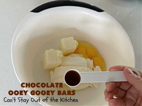 Chocolate Ooey Gooey Bars | Can't Stay Out of the Kitchen | You'll be raving over every drool-worthy bite of these fantastic #OoeyGooeyBars. They're made with 3 kinds of #chocolate & just ooze deliciousness in every bite. The #Cheesecake layer alone will leave you swooning! #cookie #brownie #tailgating #dessert, #CreamCheese #ChocolateChips #ChocolateDessert #HolidayDessert #OoeyGooeyDessert #ChocolateOoeyGooeyBars