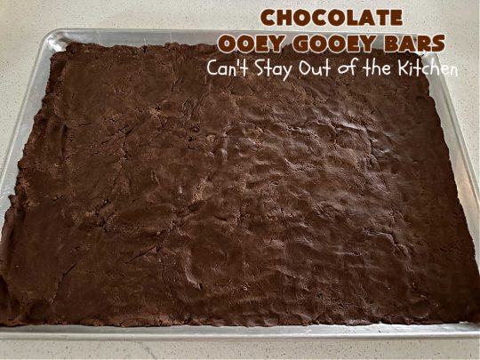 Chocolate Ooey Gooey Bars | Can't Stay Out of the Kitchen | You'll be raving over every drool-worthy bite of these fantastic #OoeyGooeyBars. They're made with 3 kinds of #chocolate & just ooze deliciousness in every bite. The #Cheesecake layer alone will leave you swooning! #cookie #brownie #tailgating #dessert, #CreamCheese #ChocolateChips #ChocolateDessert #HolidayDessert #OoeyGooeyDessert #ChocolateOoeyGooeyBars