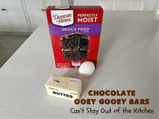 Chocolate Ooey Gooey Bars | Can't Stay Out of the Kitchen | You'll be raving over every drool-worthy bite of these fantastic #OoeyGooeyBars. They're made with 3 kinds of #chocolate & just ooze deliciousness in every bite. The #Cheesecake layer alone will leave you swooning! #cookie #brownie #tailgating #dessert, #CreamCheese #ChocolateChips #ChocolateDessert #HolidayDessert #OoeyGooeyDessert #ChocolateOoeyGooeyBars