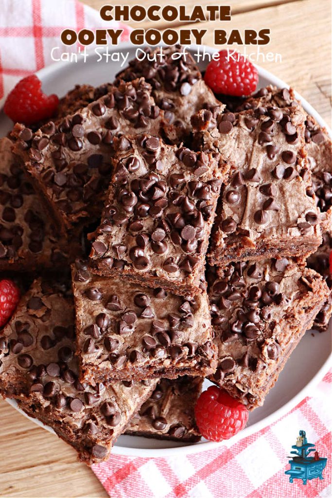 Chocolate Ooey Gooey Bars | Can't Stay Out of the Kitchen | You'll be raving over every drool-worthy bite of these fantastic #OoeyGooeyBars. They're made with 3 kinds of #chocolate & just ooze deliciousness in every bite. The #Cheesecake layer alone will leave you swooning! #cookie #brownie #tailgating #dessert, #CreamCheese #ChocolateChips #ChocolateDessert #HolidayDessert #OoeyGooeyDessert #ChocolateOoeyGooeyBars