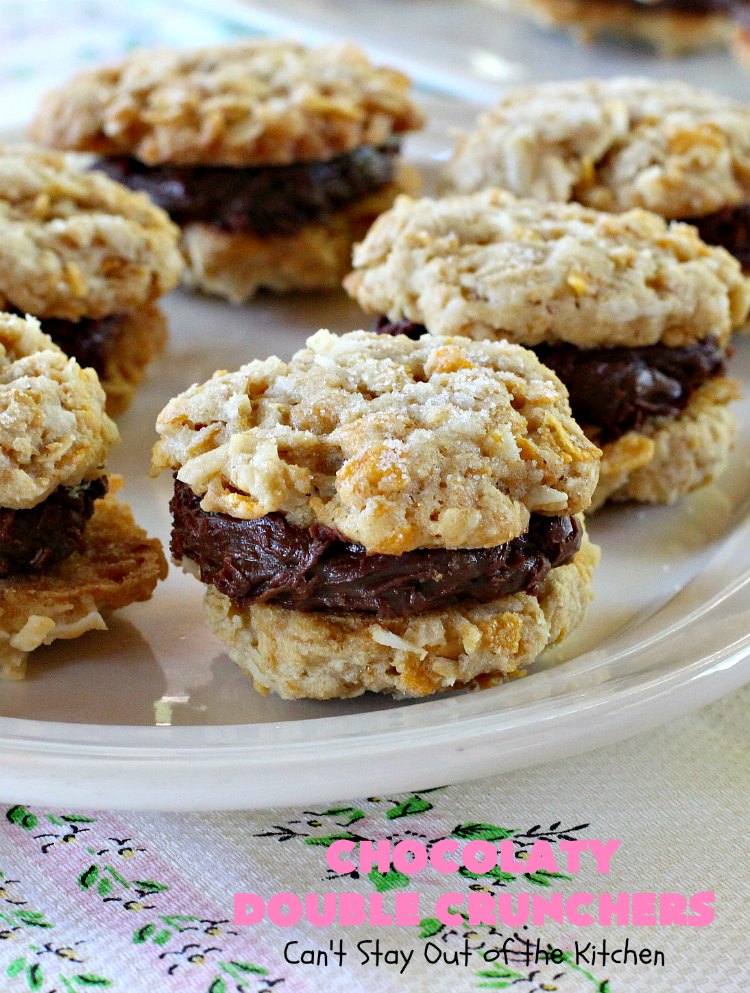 Chocolaty Double Crunchers | Can't Stay Out of the Kitchen | this scrumptious #cookie #recipe is to die for! The cookies contain #oatmeal, #CornFlakes & #coconut. The #chocolate frosting is made from #ChocolateChips & #CreamCheese. Absolutely mouthwatering #dessert for #tailgating, potlucks or #ChristmasCookieExchanges. #ChocolateDessert #WhoopiePie #OatmealWhoopiePie#ChocolatyDoubleCrunchers #SandwichCookie #OatmealSandwichCookie