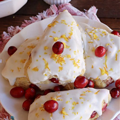 Cranberry Orange Scones | Can't Stay Out of the Kitchen | these luscious #scones have the most spectacular combination of flavors using fresh #cranberries, #OrangeZest & featuring a luscious #orange icing with more Orange Zest on top. They simply beg to be eaten! You'll be swooning after sinking your teeth into these amazing #CranberryOrangeScones. Great for a weekend, company or #holiday #breakfast or #brunch like #Thanksgiving, #Christmas, #NewYearsDay or #ValentinesDay.