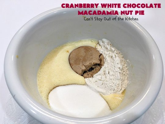 Cranberry White Chocolate Macadamia Nut Pie | Can't Stay Out of the Kitchen | this irresistible #pie is made with dried #cranberries, #MacadamiaNuts & #WhiteChocolateChips. It's so rich & decadent you'll be hooked from your first bite. Wonderful for #holiday parties and #Christmas dinner menus. #chocolate #dessert #Craisins #HolidayDessert #ChocolateDessert #CranberryDessert #CranberryWhiteChocolateMacadamiaNutPie